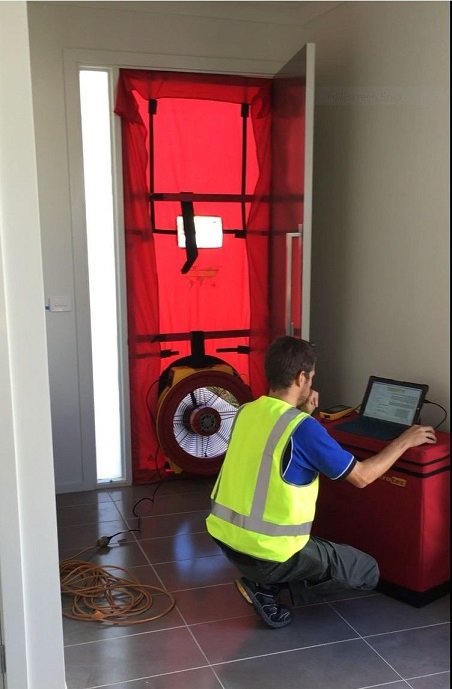 A Photo of technician testing a houses airtightness
