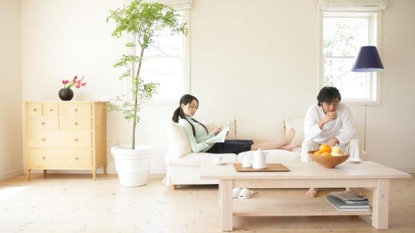  woman reading and man drinking cup tea