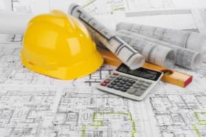 displaying construction maps, calculator, helmet purporting a TAC meeting